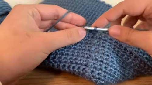 Detail of a crocheted shoulder strap worked around the armhole opening