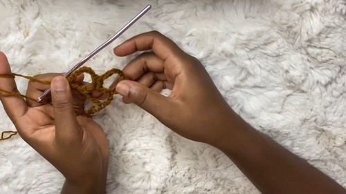 Close-up of hands starting the chain foundation for the mesh dress 