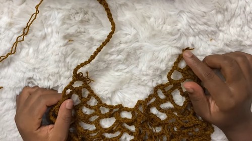 Crocheting the open mesh pattern near the straps of the swimwear cover dress 