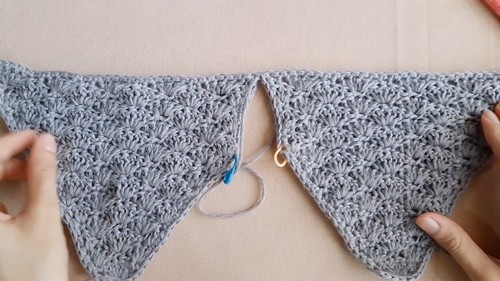 Close-up of the shell-stitch texture on the bust of a handmade crochet peplum top.