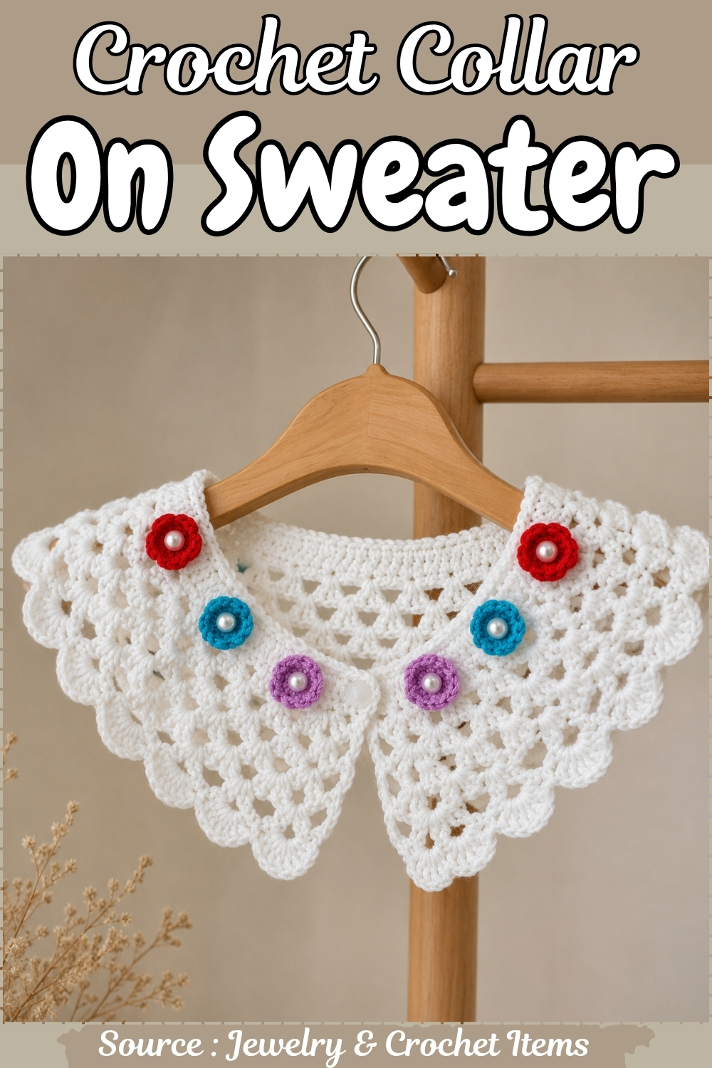 White crochet collar on a wooden hanger decorated with small red, blue and purple flowers each with a pearl center, scalloped fan lace edging
