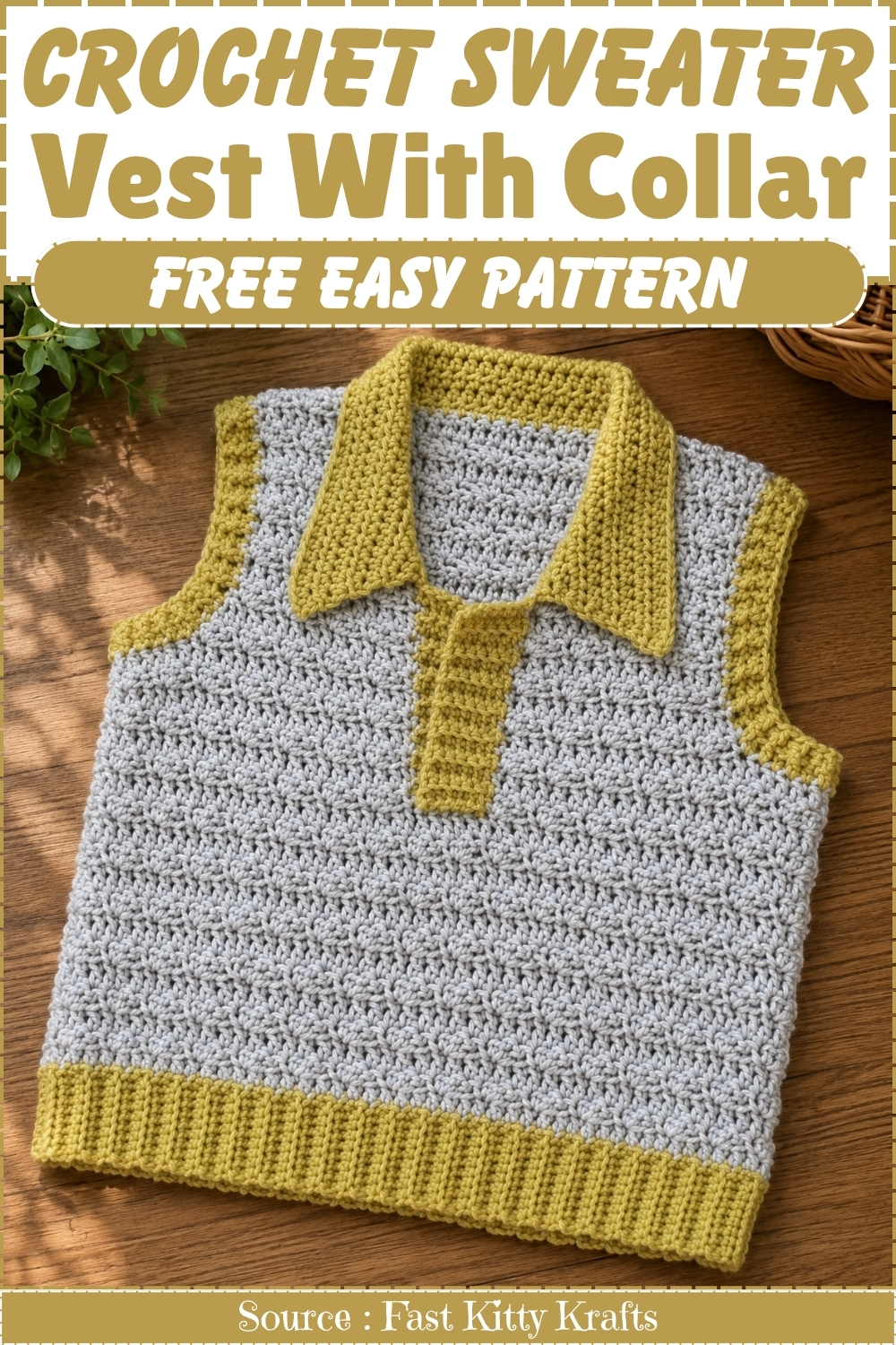 Crochet sweater vest with collar pattern pin showing the finished piece laid flat on a wood surface in light grey with mustard yellow collar trim armhole edging and ribbed hem.
